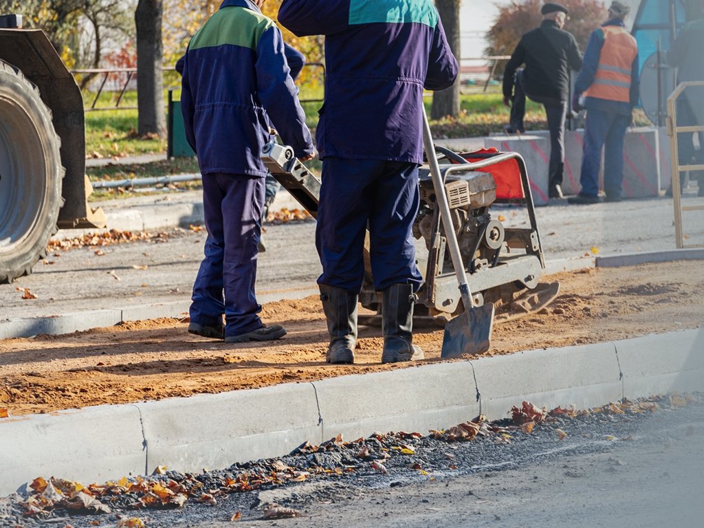 Licensed Manhattan sidewalk repair crew at work on a residential walkway