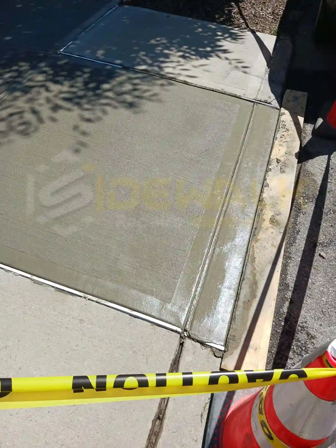 broken sidewalk getting repaired in manhattan by two professionals