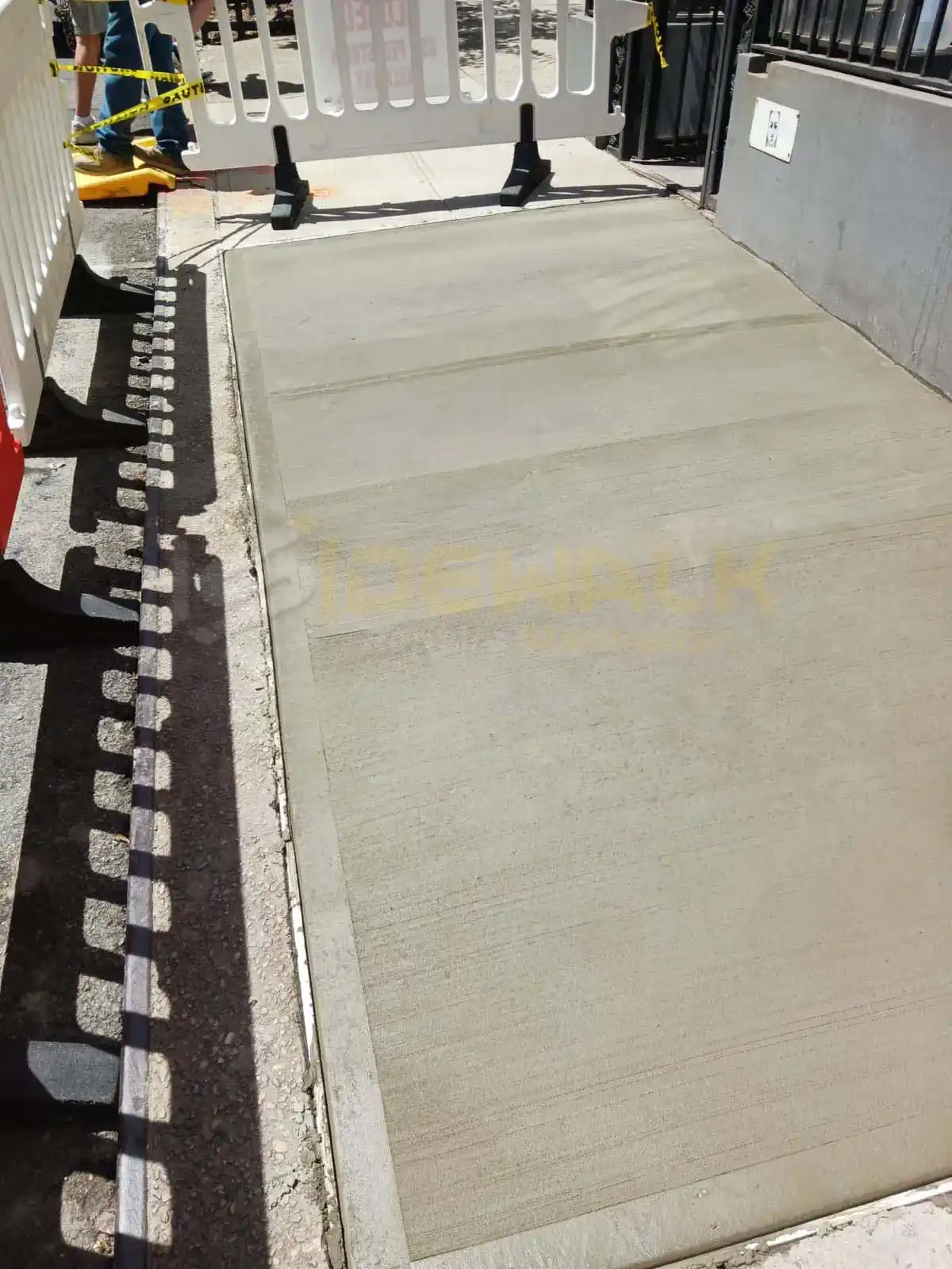 Installation of a heated concrete sidewalk system underway on the sidewalk, enhancing winter safety and comfort.